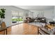 Bright living room featuring hardwood floors, neutral paint, and sliding glass doors to the backyard at 7751 S Race St, Centennial, CO 80122