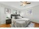 Bright main bedroom with hardwood floors, stylish decor, ceiling fan, and natural light at 7751 S Race St, Centennial, CO 80122