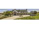 Stately clubhouse with a covered porch and golf carts parked nearby at 3973 N Rome St, Aurora, CO 80019