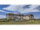 Expansive hotel with multiple stories, blue umbrellas, and lawn seating at 3973 N Rome St, Aurora, CO 80019