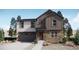 Charming two-story home features stone accents, vertical siding, and a two-car garage at 3973 N Rome St, Aurora, CO 80019