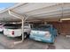 A view of the carport showing the metal support structure and multiple parked vehicles at 9019 E Oxford Dr, Denver, CO 80237