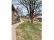Long shot of the community with sidewalks, green lawns, trees and multiple buildings at 9019 E Oxford Dr, Denver, CO 80237