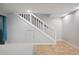 Spacious basement area with tiled floors, stairs, and good lighting at 9019 E Oxford Dr, Denver, CO 80237