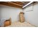 Unfinished basement featuring exposed ceiling beams, concrete walls, and tile flooring, ready for customization and personalization at 9019 E Oxford Dr, Denver, CO 80237