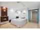 Cozy basement featuring a faux fireplace, neutral decor, and a comfortable bed at 9019 E Oxford Dr, Denver, CO 80237