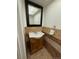 Compact half-bathroom with a sink vanity, large mirror, and decorative tile backsplash at 9019 E Oxford Dr, Denver, CO 80237
