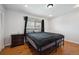 Bedroom with hardwood floors, a window with blinds, and a nightstand at 9019 E Oxford Dr, Denver, CO 80237