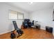 Bonus room including an exercise bench, desk with computer, and guitar at 9019 E Oxford Dr, Denver, CO 80237