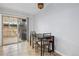 Cozy dining area featuring tile flooring, natural light, and a sliding glass door to the outside at 9019 E Oxford Dr, Denver, CO 80237