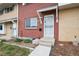 Charming red brick townhouse with a secure front door and an inviting, well-kept lawn at 9019 E Oxford Dr, Denver, CO 80237
