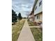 Exterior view of townhouses with well-manicured lawns and mature trees, offering a welcoming residential atmosphere at 9019 E Oxford Dr, Denver, CO 80237