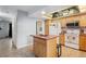 Spacious kitchen featuring an island, white appliances, and bright lighting; open layout with tile flooring at 9019 E Oxford Dr, Denver, CO 80237