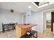 Well-lit kitchen with island and tile flooring; features a skylight and access to a laundry area at 9019 E Oxford Dr, Denver, CO 80237