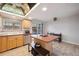 Kitchen area with island and sink, complemented by bright lighting and a partial view of the backyard at 9019 E Oxford Dr, Denver, CO 80237