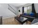 Cozy living room featuring tile flooring, a modern gray sofa, and staircase to upper level at 9019 E Oxford Dr, Denver, CO 80237