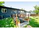 Home's backyard featuring a deck and a garden at 332 Maple Dr, Frederick, CO 80530