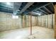 Spacious unfinished basement with exposed beams and concrete walls, ready for your personal touch at 332 Maple Dr, Frederick, CO 80530