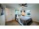 Cozy bedroom featuring a ceiling fan and two windows for natural light at 332 Maple Dr, Frederick, CO 80530