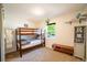 Bedroom with bunk beds, a window, and decor shelves creating a cozy space at 332 Maple Dr, Frederick, CO 80530