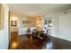 Inviting dining room featuring a rustic wood table, bench, and hardwood floors at 332 Maple Dr, Frederick, CO 80530