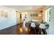 Dining room with hardwood floors, a sliding barn door, and lots of natural light at 332 Maple Dr, Frederick, CO 80530