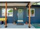Inviting front porch with wood columns, bench seating, plants, and a stylish wreath at 332 Maple Dr, Frederick, CO 80530