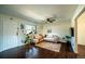 Open living room with hardwood floors, a ceiling fan, and a stylish sectional sofa at 332 Maple Dr, Frederick, CO 80530