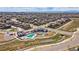 Aerial view of the community clubhouse, pool, and surrounding neighborhood at 4755 Memphis St # 2, Denver, CO 80239