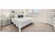 Bright bedroom featuring neutral walls, wood accent headboard, and plush carpet at 4755 Memphis St # 2, Denver, CO 80239