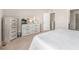 Bedroom featuring light wood dresser with mirror and access to closet at 4755 Memphis St # 2, Denver, CO 80239