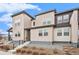 Stylish townhouse with modern design elements, featuring neutral siding, concrete steps, and minimalistic landscaping at 4755 Memphis St # 2, Denver, CO 80239