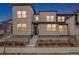 Modern two-story house showcasing a sleek design, well-maintained yard, and inviting entrance, enhanced by twilight at 4755 Memphis St # 2, Denver, CO 80239