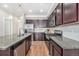 Beautiful kitchen with stainless steel appliances, granite countertops, a kitchen island and dark wood cabinetry at 4755 Memphis St # 2, Denver, CO 80239