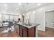 Kitchen island with a double sink and granite countertops, adjacent to dining area with seating and large windows at 4755 Memphis St # 2, Denver, CO 80239