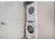 Laundry area featuring stacked washer and dryer, and white door at 4755 Memphis St # 2, Denver, CO 80239
