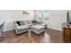 Inviting living room showcases a plush gray sectional, accent pillows, and a window offering lots of natural light at 4755 Memphis St # 2, Denver, CO 80239