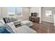 Comfortable living room featuring a large gray sectional sofa, fireplace, and plenty of natural light from the windows at 4755 Memphis St # 2, Denver, CO 80239