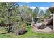 Beautifully landscaped backyard with a stone patio, comfortable seating, and a cozy fire pit for outdoor enjoyment at 5055 Mcclure Ln, Castle Rock, CO 80108