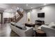 Finished basement has light gray walls, luxury vinyl plank flooring and a winding wooden staircase at 5055 Mcclure Ln, Castle Rock, CO 80108