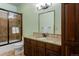 Bathroom features granite countertop vanity, modern shower stall with glass door, and toilet at 5055 Mcclure Ln, Castle Rock, CO 80108