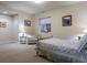 Cozy bedroom features carpet, a quaint chair, and a bed with floral patterned comforter at 5055 Mcclure Ln, Castle Rock, CO 80108