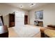 Neutral bedroom features hardwood cabinets, a Murphy bed, and an office desk with a chair at 5055 Mcclure Ln, Castle Rock, CO 80108