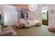 Well-lit bedroom features decorative chandelier, a queen bed, and view to bathroom at 5055 Mcclure Ln, Castle Rock, CO 80108