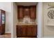 Charming butler's pantry with wooden cabinets, countertop and backsplash details at 5055 Mcclure Ln, Castle Rock, CO 80108