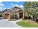 Charming home featuring a stone-accented entrance, arched doorway, and a well-manicured front yard at 5055 Mcclure Ln, Castle Rock, CO 80108