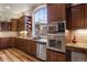 Kitchen featuring stainless steel appliances, granite countertops, and a large arched window at 5055 Mcclure Ln, Castle Rock, CO 80108