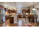 Open kitchen featuring hardwood floors, stainless steel appliances, and island with seating at 5055 Mcclure Ln, Castle Rock, CO 80108
