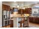 Gourmet kitchen with stainless appliances, custom cabinetry, granite counters, and breakfast bar at 5055 Mcclure Ln, Castle Rock, CO 80108