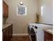 Functional laundry room with modern appliances, cabinets, and countertop space at 5055 Mcclure Ln, Castle Rock, CO 80108